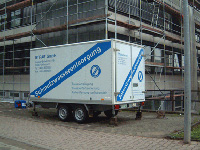 ETRAS trailer in front of scaffolding